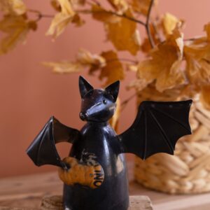 Recycled Metal Bat Holding a Pumpkin
